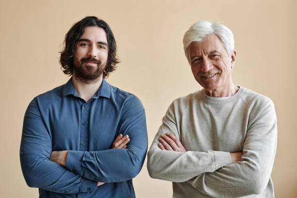 istock Adult father and son looking at camera 1503229585