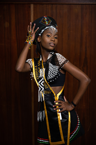 Three quarter length portrait young teenager wearing traditional dress in beauty pageant