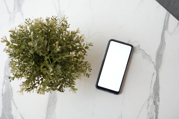 istock Blank screen cell phone with empty copy space mockup on tiles background , 1503229755