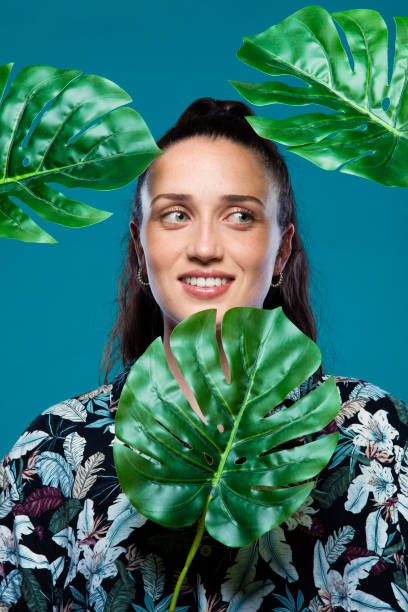 istock Woman behind green leaves in studio 1503230316