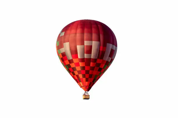 Photo of Red hot air balloon with basket isolated on white background