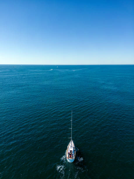 Aerial view of solo yacht sailing off the coastal Pacific Ocean, Australia
