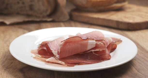 istock Italian speck ham on a plate on wood table 1503234062