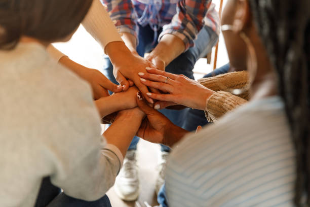 istock Diverse people holding hands stacked together after a successful group therapy session 1503234836