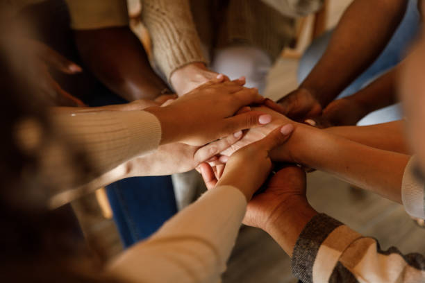 istock Diverse people holding hands stacked together after a successful group therapy session 1503234837