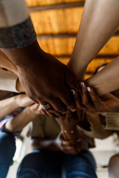 istock Diverse people holding hands stacked together after a successful group therapy session 1503234839