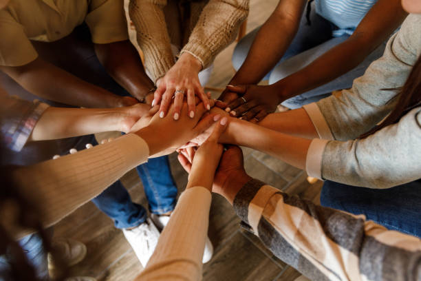 istock Diverse people holding hands stacked together after a successful group therapy session 1503234841