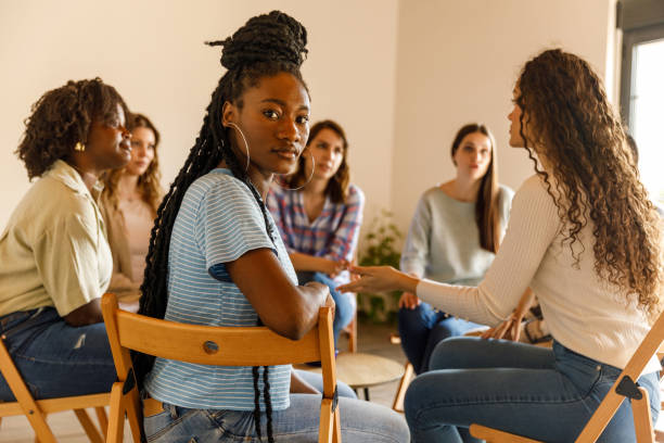 istock Young woman turning around and looking at camera during a group therapy session 1503235100