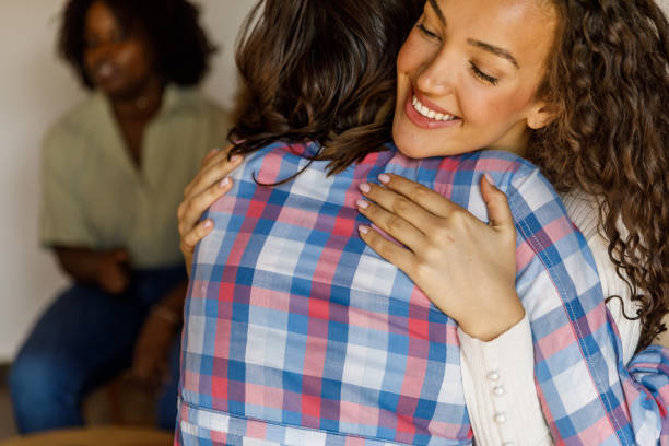 istock Two young women hugging during a successful group therapy session 1503236297