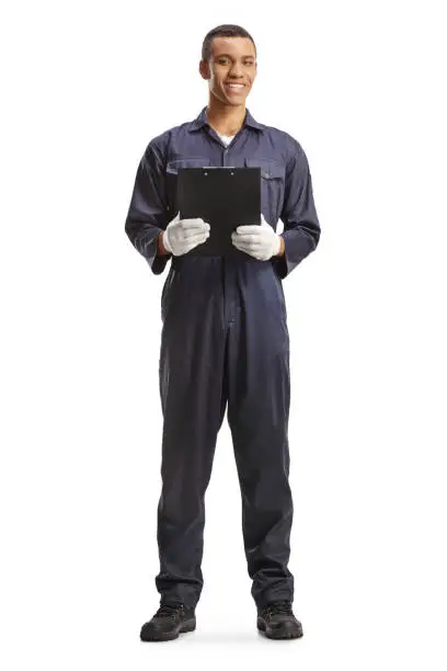 Full length portrait of an african american car mechanic holding a clipboard and smiling isolated on white background