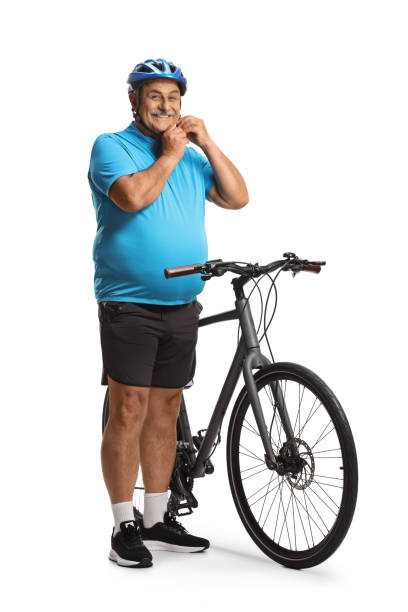 Mature man with a bicycle putting on a helmet Mature man with a bicycle putting on a helmet isolated on white background man 60s bicycle stock pictures, royalty-free photos & images