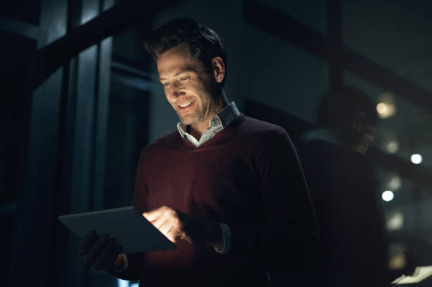 istock Business, night and man with a tablet, connection and search internet with network, website information and typing. Male person, web designer and employee check software, data update and working late 1503241482