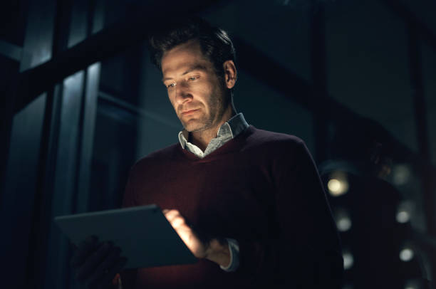 istock Night, business and man with a tablet, internet and connection with digital planning, cyber security and deadline Male person, dark or web designer with technology, software update and online reading 1503241483