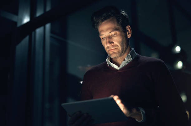 istock Night, business and man with a tablet, typing and network with digital planning, internet or cyber security. Male person, web designer or entrepreneur with tech, software update or dark with deadline 1503241493