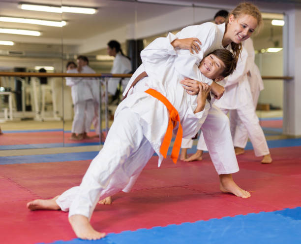 istock Girl doing throw over her shoulder at self-defense lesson 1503245816