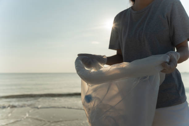 istock Save ocean. Volunteer pick up trash garbage at the beach and plastic bottles are difficult decompose prevent harm aquatic life. Earth, Environment, Greening planet, reduce global warming, Save world 1503249807
