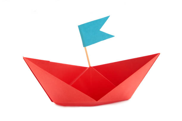istock Leadership concept. Red leader paper ship leading isolated on white background. 1503249875