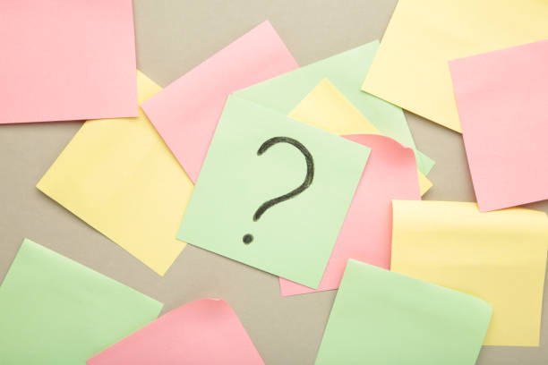 istock Question marks on colour stickers on grey background. Top view. 1503251239