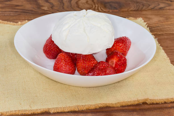 istock Ice cream piece atop fresh strawberry on the white dish 1503252301