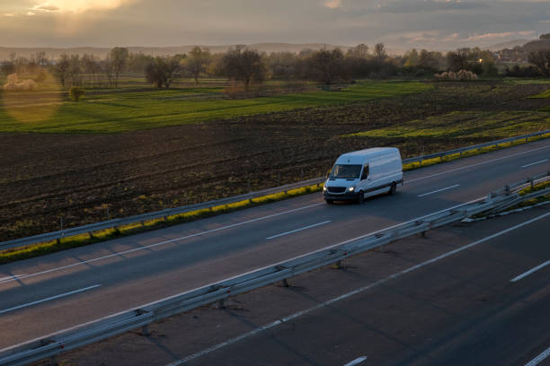 istock White delivery van on the highway. White modern delivery small shipment cargo courier van moving fast on motorway road to city urban suburb. The world's best transport of goods. 1503252698
