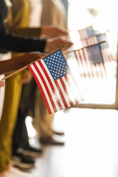istock Group of people standing in line, holding American flags 1503253063