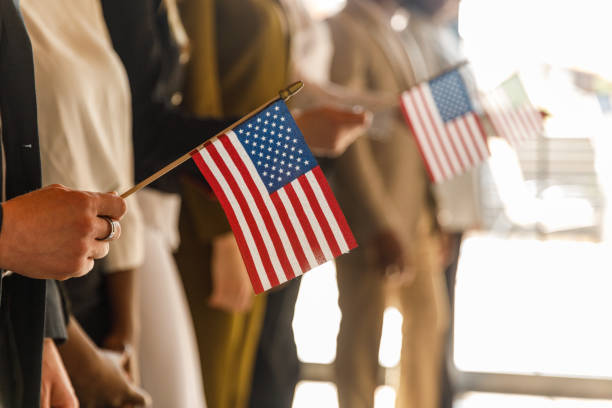 istock Group of people standing in line, holding American flags 1503253076