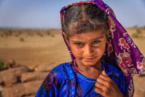 Happy Gypsy Indian little girl - desert village, Thar Desert, Rajasthan, India.