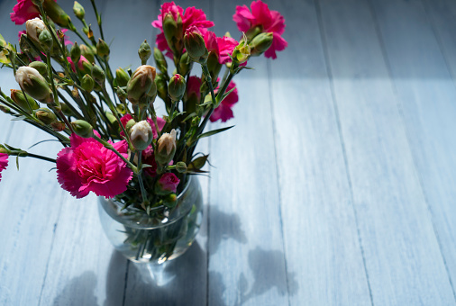 Rose buds in glass jar. Selective focus.