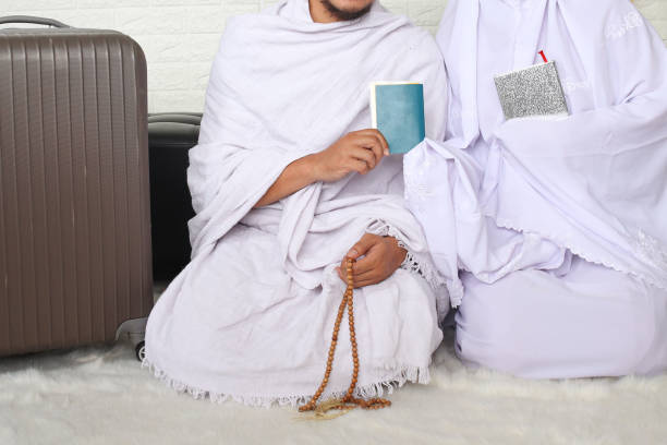 Close up of young couple wearing ihram clothes prepare to hajj