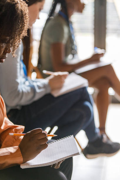 Business people taking notes during a presentation or a seminar