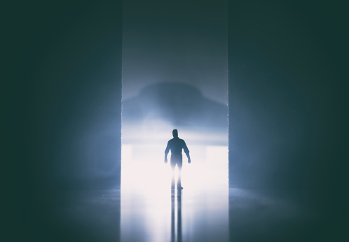 Man walking in dark tunnel