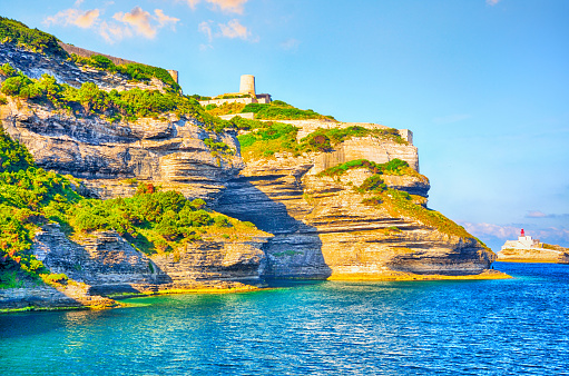 Lighthouse on cliffs above the Mediterranean sea near old town Bonifacio, Corsica, France. Composite photo