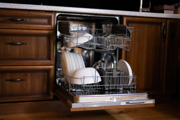 istock Open dishwasher with clean dishes in wooden surface kitchen. 1503262221