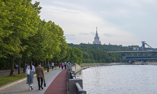 Russia, Moscow, June 25, 2023--People walk along the embankment of the Moscow River in sunny weather in summer