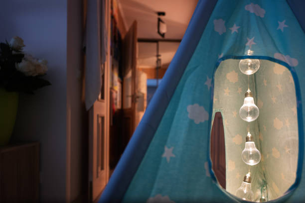 istock Light bulbs in children tent at room in evening. 1503262302
