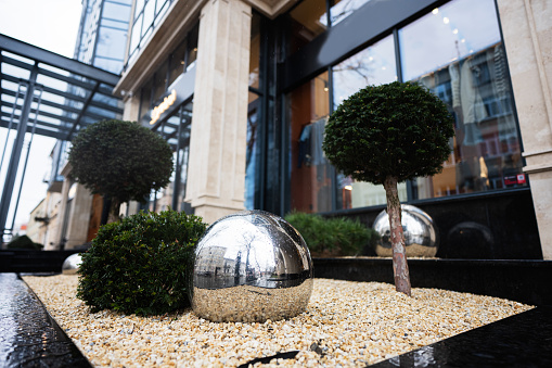 Shiny metallic mirror reflection balls,  urban decoration of modrern buildings.