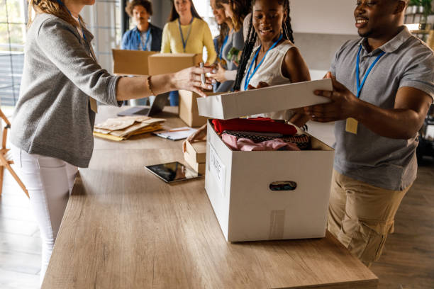 istock Group of volunteers preparing boxes with donations for less fortunate 1503273705