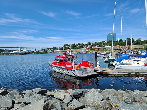Dartmouth, NS, CAN, 8.29.2022 - Vessels docked along the shore in Dartmouth, Nova Scotia on a clear summer day.
