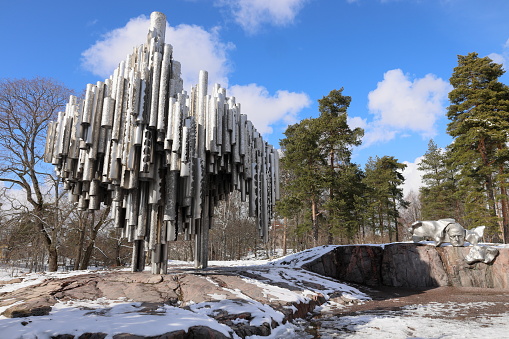 The Sibelius Monument by Eila Hiltunen, dedicated to the Finnish composer Jean Sibelius in  Sibelius Park, Töölö, Helsinki, Finland. Captured with snow on the ground, the abstract monument, entitled Passio Musicae, was created by artist Eila Hiltunen and is  a bundle of 600 steel tubes resembling a pipe organ. Beside the monument is a bust of the composer.