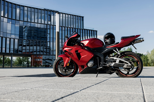 Minsk, Belarus, June 2023 - Red and black sportbike Honda CBR RR on glass building background