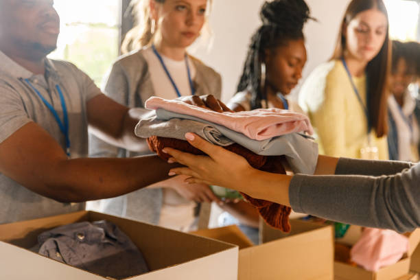 istock Group of volunteers preparing donation boxes with clothes 1503277952