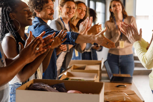 istock Group of volunteers applauding after successfully preparing donations 1503277967