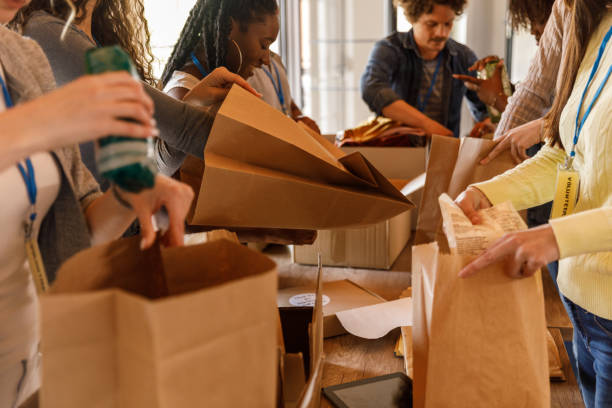 Volunteers creating care packages during a food drive stock photo