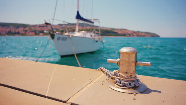 SLO MO Elegant Yacht Secured with Rope on Harbor Mooring Post on Sunny Day