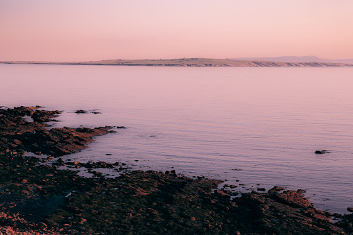 Looking across to a dreamlike Orkney Islands in the north of the United Kingdom with a solstice dawn.