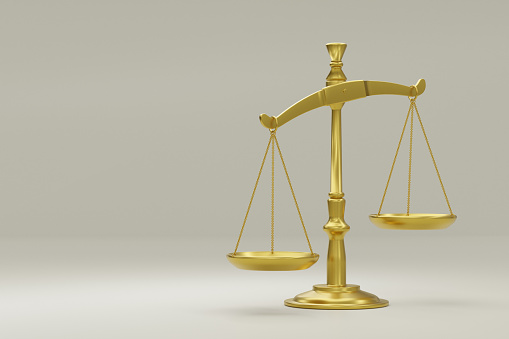 Golden scales isolated on beige backdrop, justice or imbalance concept