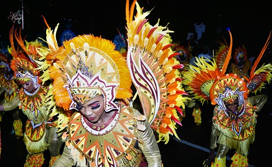 Nassau, Bahamas – January 01, 2023: A closeup of  women dressed in bright, vibrant  costumes at the New Year's Day Junkanoo Street parade in The Bahamas