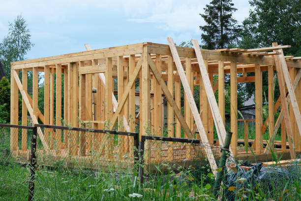 Exterior framing of a new house under construction frame stick Construction of a wooden house in nature. Cottage frame from boards and timber wood and wire fence designs pictures stock pictures, royalty-free photos & images
