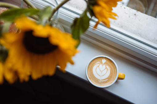 Latte art and beautiful sunflowers