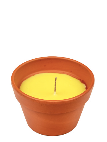 Yellow citronella candle, new, in a clay pot. A mosquito repellant for outdoor use.